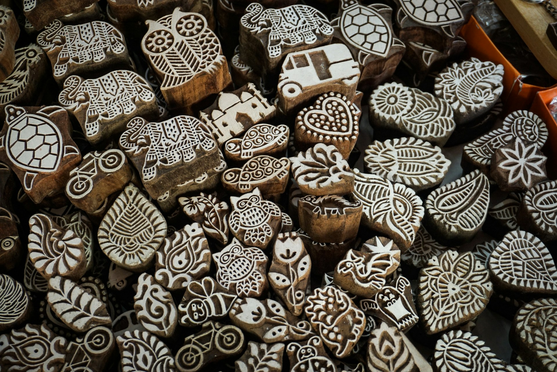 Collection of carved wooden printing blocks with various patterns.